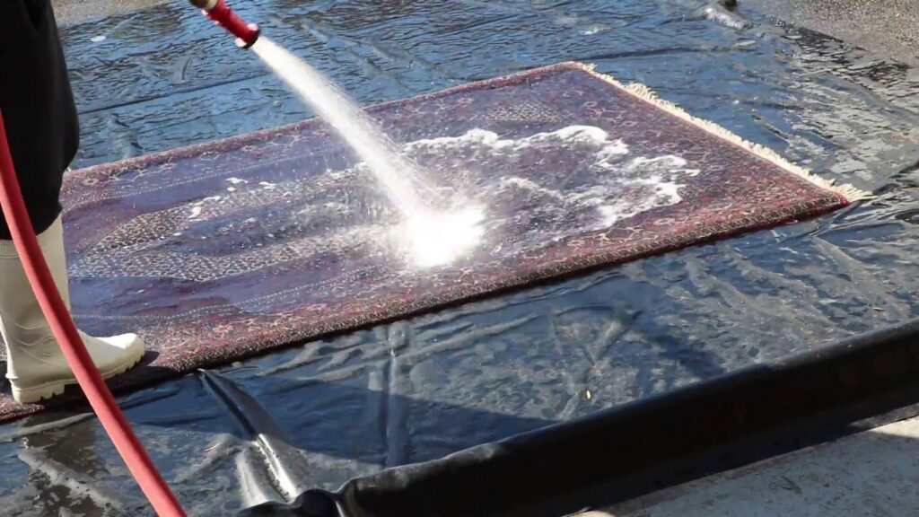 An oriental rug being cleaned with water and foam by Oriental Rug Cleaning Facility in Tampa, FL