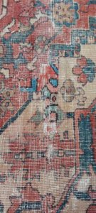 Close-up of a damaged rug showing patchwork repair by George Bell Rug Cleaning & Restoration in Jackson, MS.
