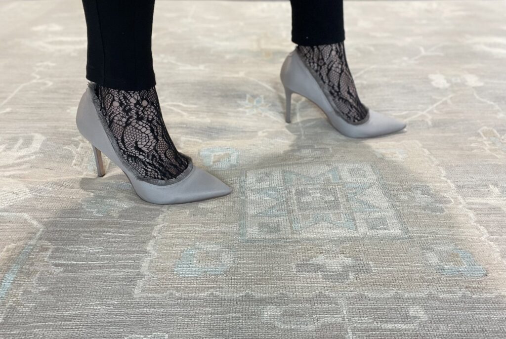 A skilled artisan performing rug repair and restoration services at Ashly Fine Rugs in Houston, TX