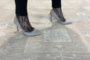 A skilled artisan performing rug repair and restoration services at Ashly Fine Rugs in Houston, TX