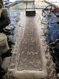 A rug runner being thoroughly cleaned with foam and a specialized machine by Rug Renew in Spring Valley, CA.