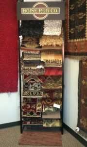 A display rack showcasing various rug samples at Boise Rug Shop in Boise, ID.