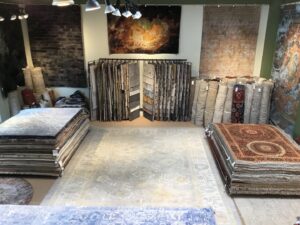 An expansive interior view of the rug showroom at David Alan Rugs in Austin, TX, featuring various rug displays.