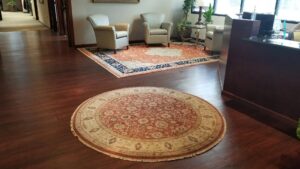 Rugs displayed as wall decor around a fireplace, showcasing products from Ebie's Rug Cache & Ebie's Rug Cleaning in Tucson, AZ