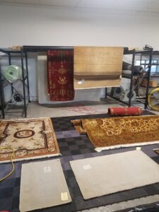 Various rugs drying or being processed in the workshop at Boise Rug Shop in Boise, ID.
