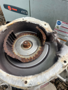 A rusted and dirty old HVAC blower wheel removed for replacement by Nashville Heating & Air in Gallatin, TN