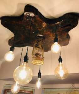 A custom rustic ceiling light fixture with Edison bulbs and a lantern installed by Calvert Electrical Service in San Antonio, TX