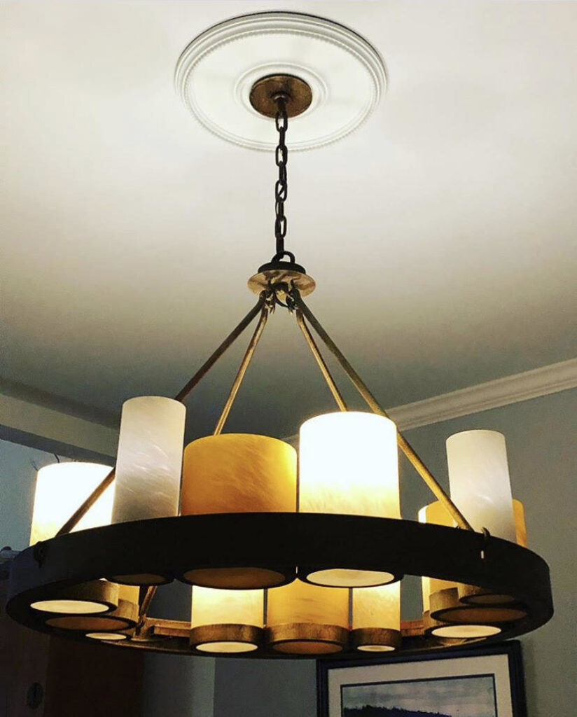 A large, rustic-style chandelier hanging from a ceiling, installed by Harbour Electric in Wilmington, NC.