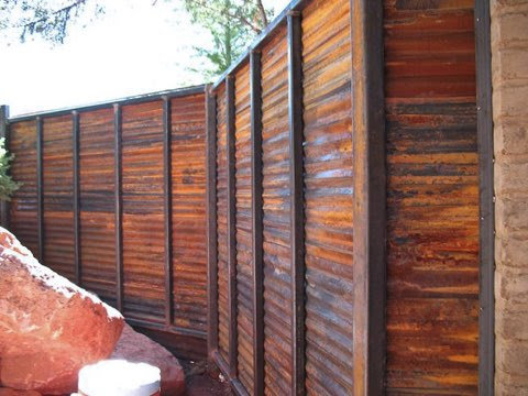 A rustic corrugated metal privacy fence installed by Fence Company Tucson in Tucson, AZ.