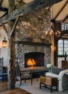 A rustic stone fireplace with a warm fire burning, showcasing services from Professional Fireplaces and Chimney Sweeps in Huntsville, AL.