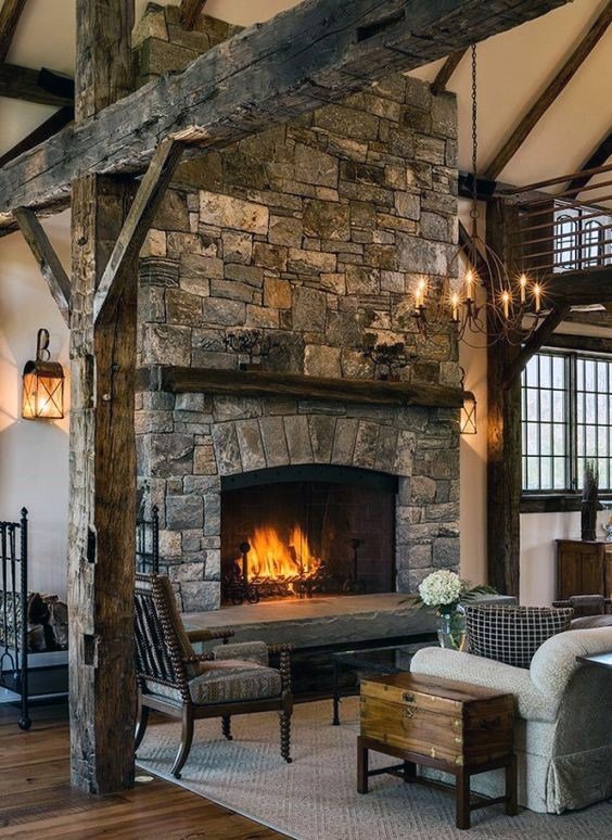 A rustic stone fireplace with a warm fire burning, showcasing services from Professional Fireplaces and Chimney Sweeps in Huntsville, AL.