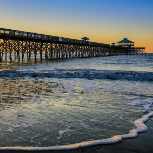 A close-up of a rusty and damaged outdoor HVAC condenser unit, indicating a need for service from Burke Services, Inc. in Folly Beach, SC.