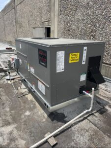A large RUUD commercial rooftop HVAC unit installed by ProTexAir HVAC Services in Houston, TX.