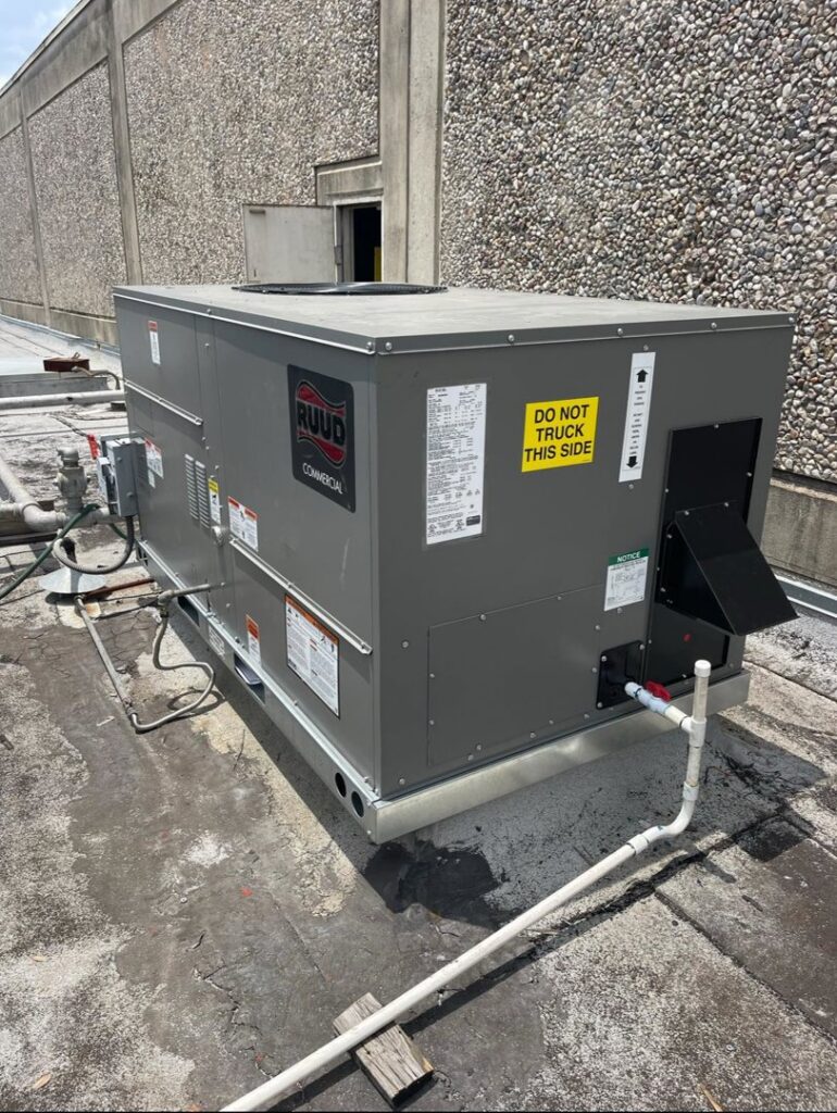 A large RUUD commercial rooftop HVAC unit installed by ProTexAir HVAC Services in Houston, TX.