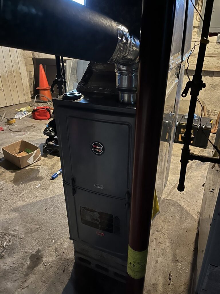 A Ruud furnace installed in a basement by Climate Diagnostics in Buffalo, NY.