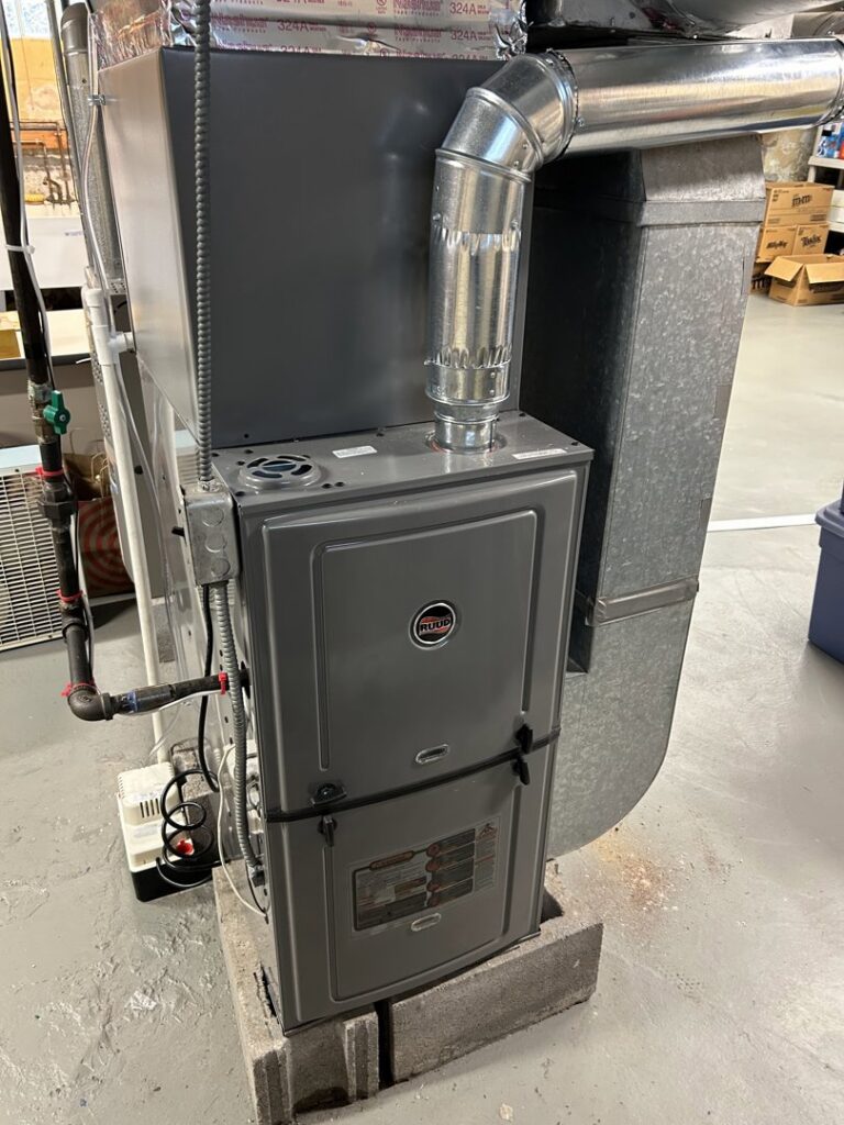 A Ruud furnace and ductwork installation in a basement by Climate Diagnostics in Buffalo, NY.