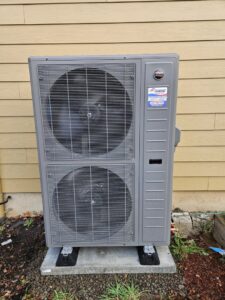 A Ruud outdoor heat pump unit installed by Conrad Heating and Cooling in Beaverton, OR.