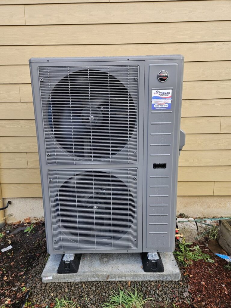 A Ruud outdoor heat pump unit installed by Conrad Heating and Cooling in Beaverton, OR.