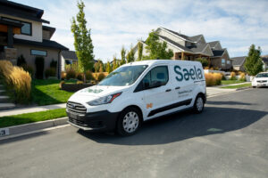 A Saela Pest Control company van parked on a neighborhood street in Hubbard, OR.