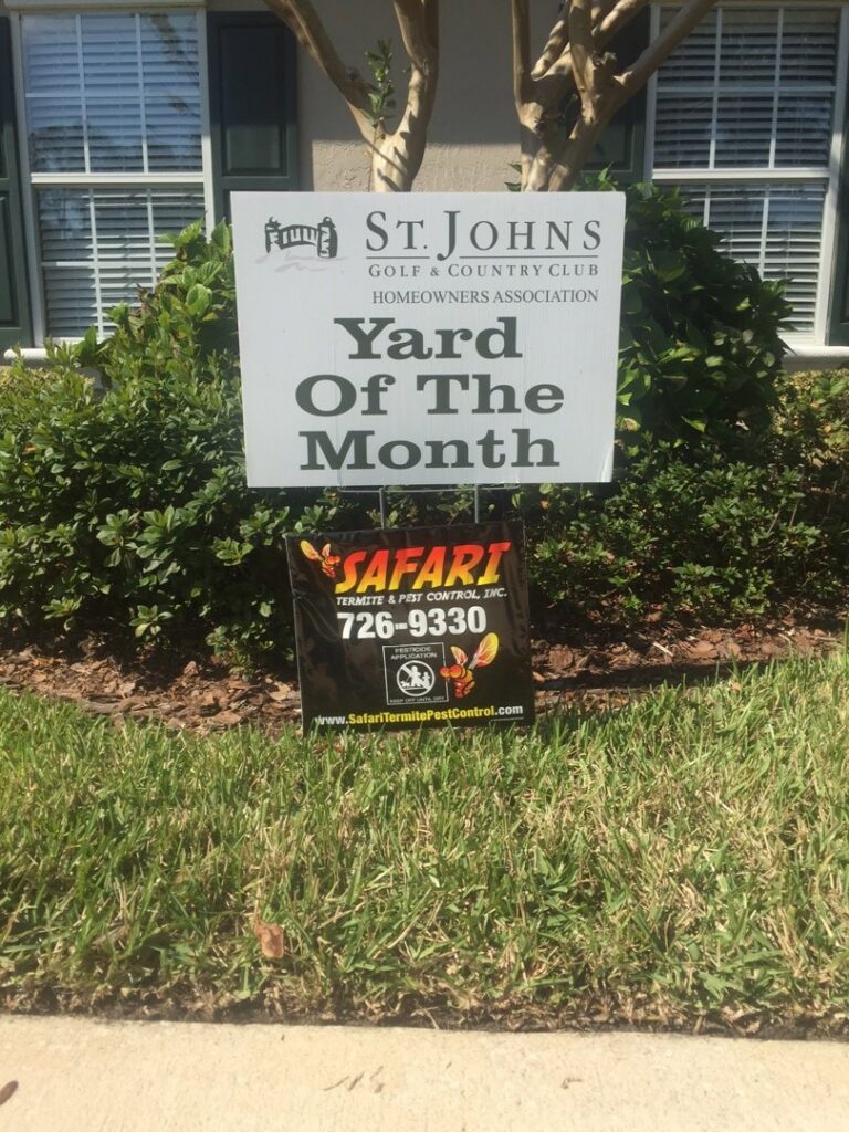 A Safari Termite and Pest Control sign displayed below a "Yard of the Month" award in Jacksonville, FL.