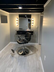 A salon or barber station with new wall-mounted lighting installed by Moss Contracting in Philadelphia, PA.