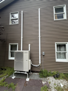 A newly installed Samsung heat pump unit on the side of a house by Rockys electric in La Junta, CO.