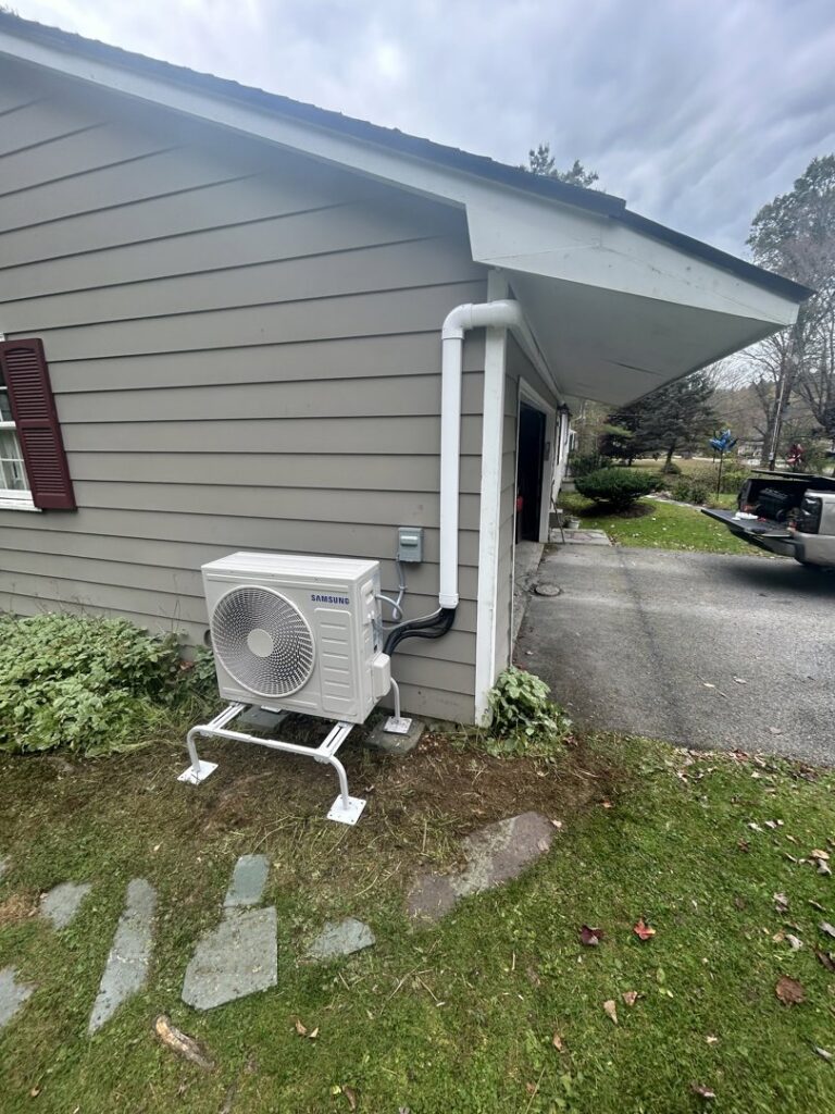 An outdoor Samsung heat pump unit installed on the side of a residential building by Rockys electric in La Junta, CO.