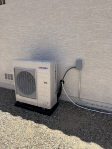 A Samsung mini-split outdoor condenser unit installed next to a building by J & M Cooling & Heating LLC in Peoria, AZ.