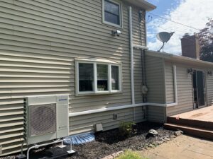 A Samsung mini-split heat pump outdoor unit installed on a home by Aire Serv of Rochester, NY