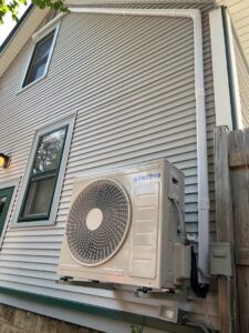 A Samsung mini-split outdoor unit installed on the side of a house by Done Right Air in West Allis, WI
