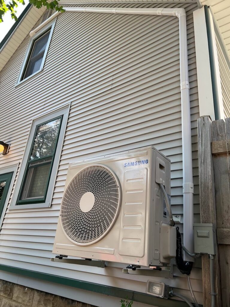 A Samsung mini-split outdoor unit installed on the side of a house by Done Right Air in West Allis, WI