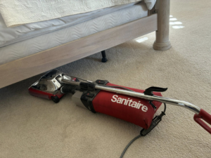 A Sanitaire professional vacuum cleaner on a light-colored carpet by Steamex Carpet Cleaning Phoenix, AZ.