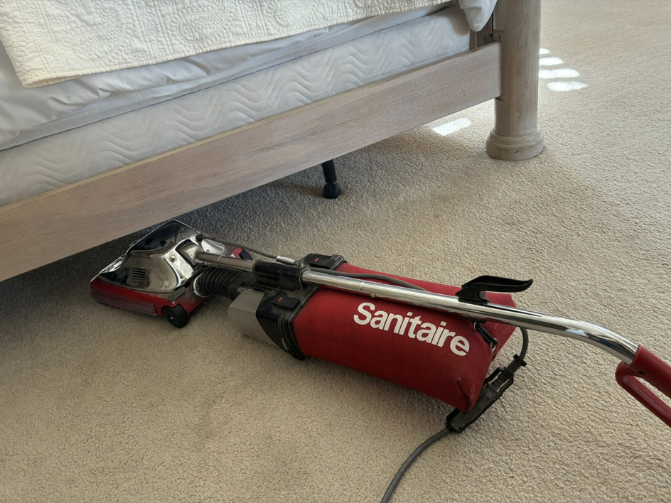 A Sanitaire professional vacuum cleaner on a light-colored carpet by Steamex Carpet Cleaning Phoenix, AZ.