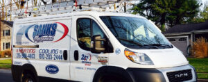 A SANKS Mechanical service van with ladders on the roof, parked on a residential street in Philadelphia, PA.