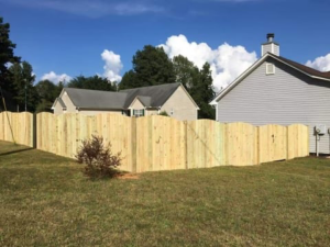 A newly installed scalloped wood privacy fence enclosing a backyard by Castillo Fences in Sacramento, CA.