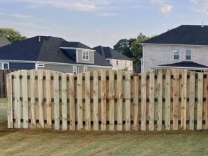 A beautifully installed scalloped wood privacy fence in a residential backyard by RUCO Fence in Huntsville, AL.