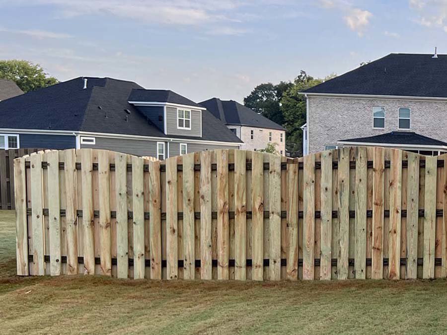 A beautifully installed scalloped wood privacy fence in a residential backyard by RUCO Fence in Huntsville, AL.