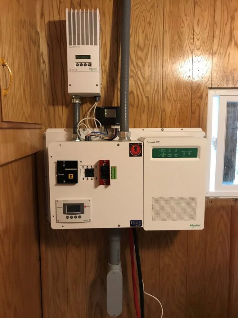 Schneider Electric solar charge controller and inverter system installed on a wooden wall by J C Electric & Solar in Lewiston, ID
