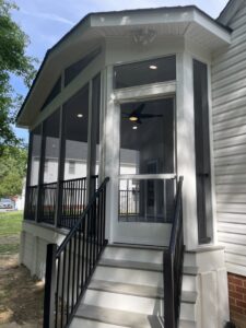 Exterior view of a screened porch with recessed lighting and a ceiling fan installed by C. C. Taylor Electric LLC in Powhatan, VA.