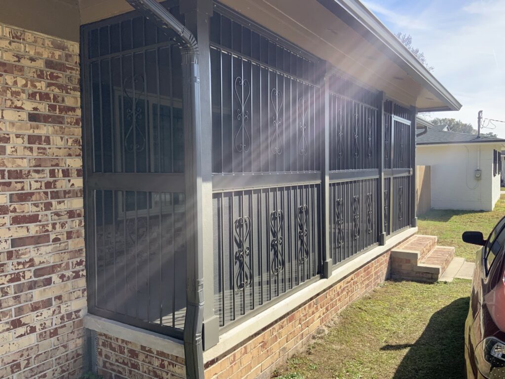 Screened-in porch with black security bars and decorative elements by Ability Burglar Bars in Jacksonville, FL.