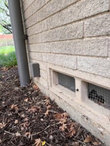 Screened vents on a brick wall, demonstrating wildlife and pest exclusion efforts by BBK Pest Control in Dallas, TX.