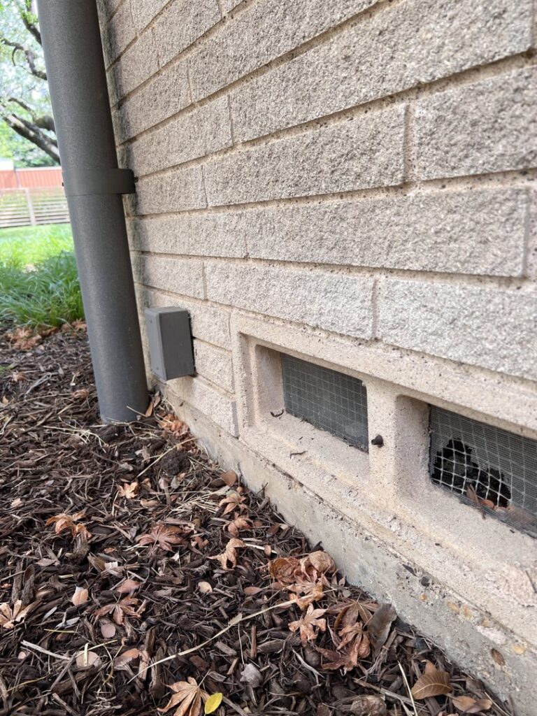 Screened vents on a brick wall, demonstrating wildlife and pest exclusion efforts by BBK Pest Control in Dallas, TX.
