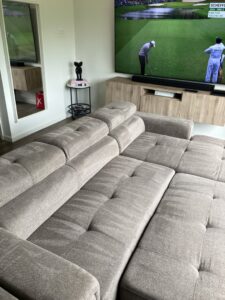 Another view of a sectional sofa with visible cleaning marks after upholstery cleaning by Carpet Kingz in Houston, TX