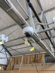 An indoor security camera with visible electrical conduit and wiring installed by D.B. Smart Homes & Security LLC in Sheridan, WY.
