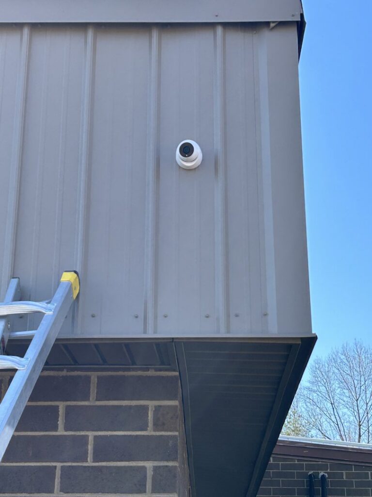 A security camera installed on a building exterior, a service provided by Mister Sparky of Greensboro in Greensboro, NC.