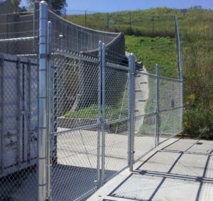 A security chain-link fence with barbed wire installed by Statewide Fencing, Inc. in Franksville, WI
