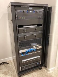 A server rack with network and electrical power equipment installed by D.B. Smart Homes & Security LLC in Sheridan, WY.