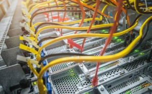 Close-up of server rack wiring with colorful cables, showcasing electrical services by Branham by Suburban Electrical Services in Olivette, MO