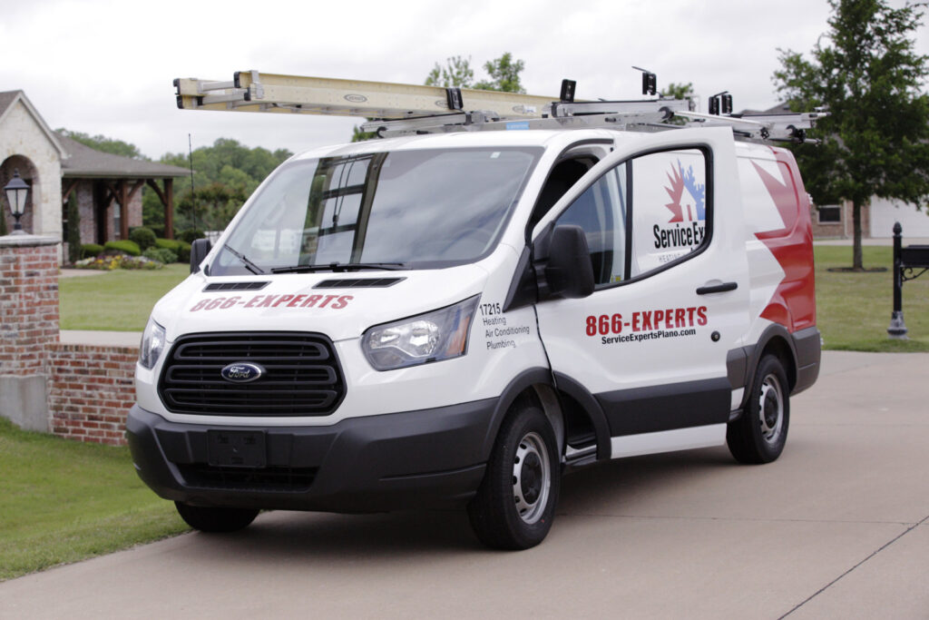 A branded service van for Komfort Air Service Experts, an HVAC and plumbing contractor, parked in Charlotte, NC.