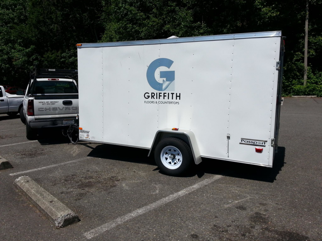A service trailer advertising 'Floors & Countertops' for Griffith Industries, Inc., a carpet contractor in Kent, WA.